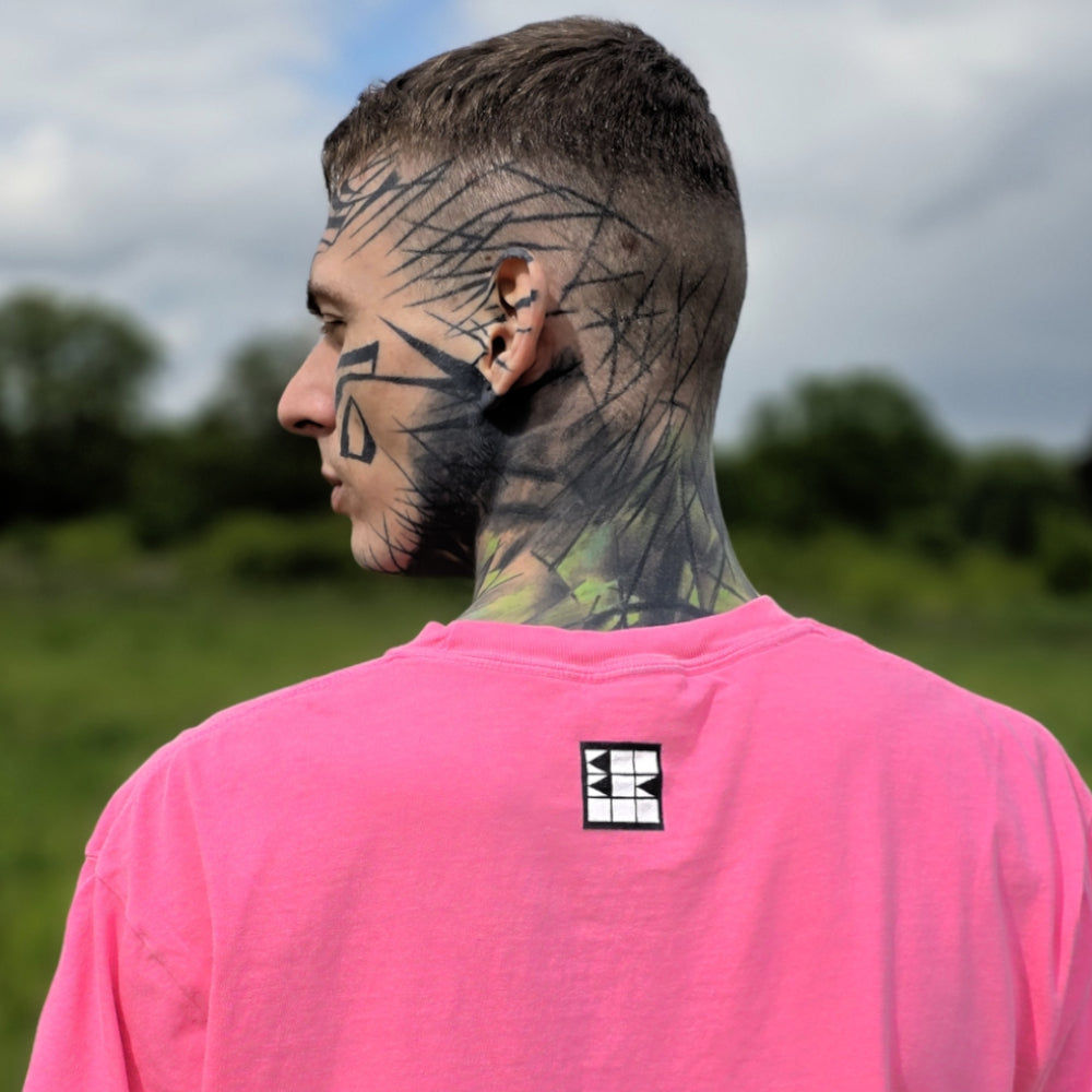 BBB Artwear, Streetwear, baobabwod, Berlin, Tattoo Model in Pink T-Shirt with Clown Design in green Nature, Tattooed Eyes, Art Label, Brand